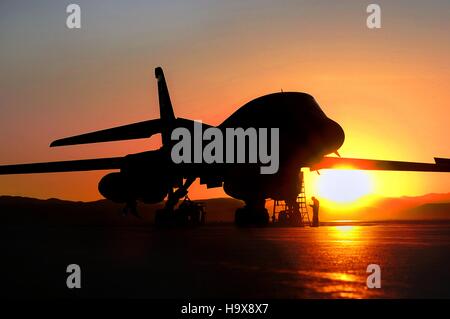 A B-1B Lancer jet-powered heavy strategic bomber aircraft sits on the runway at sunset at the Ellsworth Air Force Base November 9, 2009 near Box Elder, South Dakota. Stock Photo