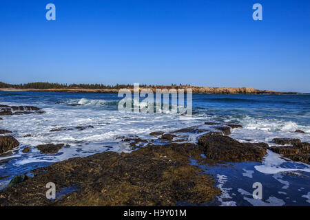 This image captures the dynamic force of crashing waves along a coastline. The powerful interaction between water and land demonstrates the natural energy shaping shorelines and contributing to coastal erosion and marine ecosystems. Stock Photo