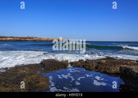 This image captures the powerful force of crashing waves along the coastline, showcasing the dynamic relationship between ocean forces and coastal ecosystems. The natural energy of waves contributes to the shaping of coastal landscapes and marine habitats. Stock Photo