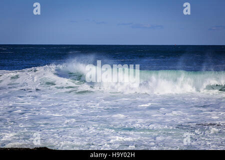 This image captures the powerful force of waves crashing on the shore, highlighting the dynamic interaction between water and the coastline. This natural phenomenon plays an important role in shaping coastal ecosystems and is a key subject of study in oceanography and environmental science. Stock Photo