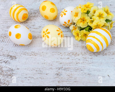 Decorated easter eggs and primrose flowers bouquet composition Stock Photo