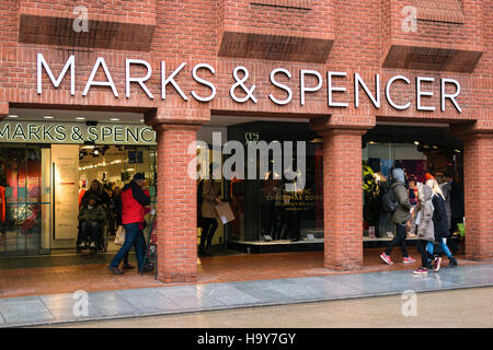 Exeter, England, UK - 22 November 2016: Unidentified people walk by Marks & Spencer store on High Street Stock Photo