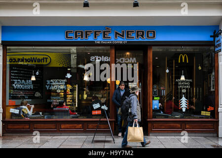 Exeter, England, UK - 22 November 2016: Unidentified people walk by Caffe Nero in Exeter, UK Stock Photo