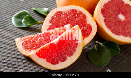 Red Grapefruit on a concrete gray background. The concept of healthy nutrition and diet. Stock Photo