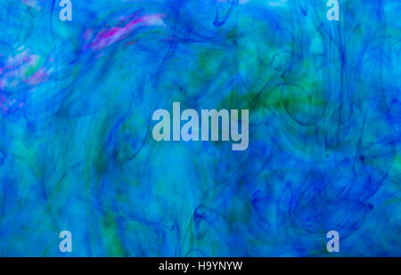 Abstract underwater color background. Color drop underwater creating a silk drapery. Ink swirling underwater. Blue and green Stock Photo