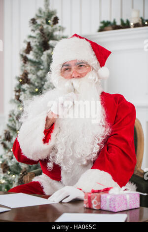 Portrait of Santa Claus answering Christmas letters Stock Photo