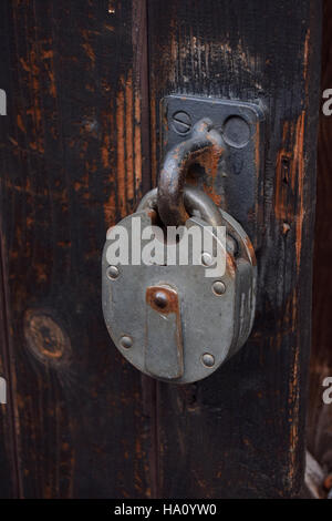 Vintage padlock on the workshop door Stock Photo