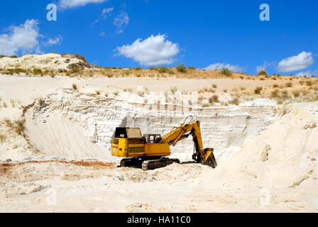 Old yellow dredge in sandy to career Stock Photo