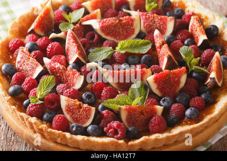 Freshly baked cake with fresh figs, raspberries and blueberries macro on the table. horizontal Stock Photo