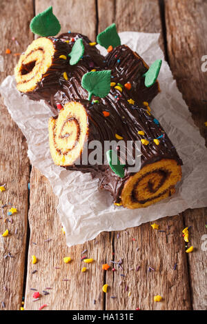 homemade buche de noel, chocolate yule log christmas cake. Vertical, rustic Stock Photo