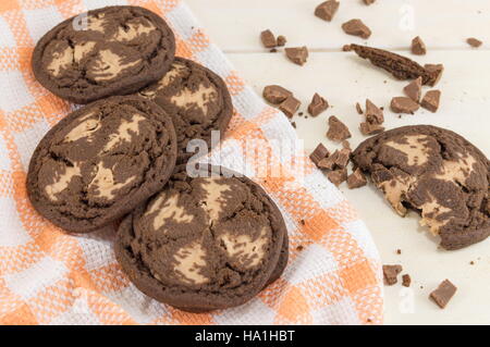 Chocolate chip brown cookies on orange tablecloth Stock Photo