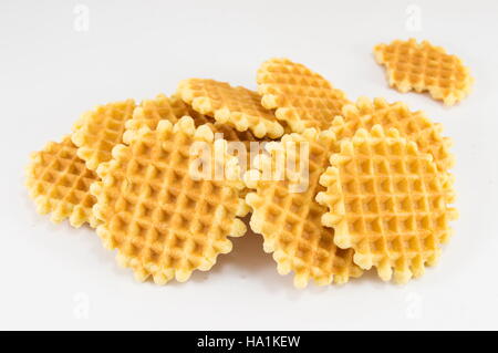 Bunch of golden baked waffle cookies on white Stock Photo