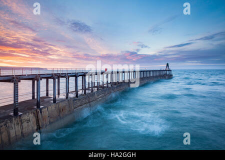 Sunset over West Pier at Whitby, North Yorkshire Stock Photo