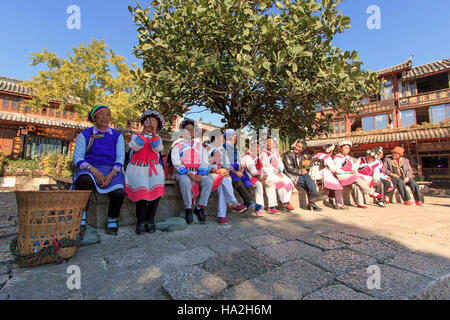 Lijiang, China - November 10, 2016: Old women dressed with the traditional attire of their minority in Lijiang Old Town Stock Photo