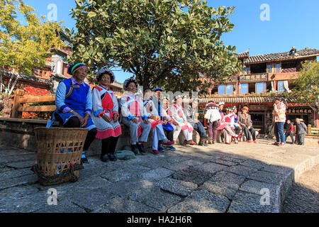 Lijiang, China - November 10, 2016: Old women dressed with the traditional attire of their minority in Lijiang Old Town Stock Photo