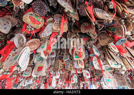 Lijiang, China - November 10, 2016: Close up of hand written prayers hanging on a roof. Stock Photo