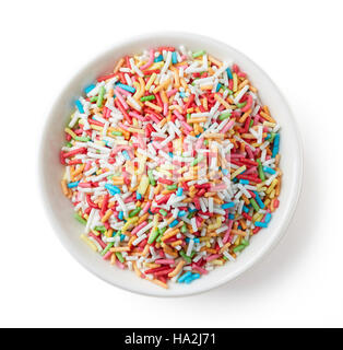 Colorful candy sprinkles in white bowl isolated on white background, top view Stock Photo