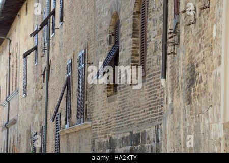 Half open vintage brown window shutters. Stock Photo