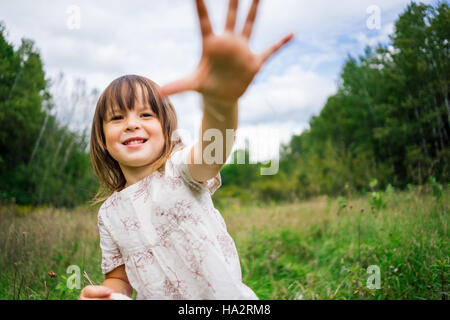 Portrait of a girl holding her hand in the air Stock Photo