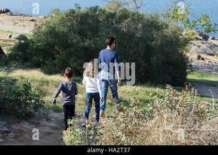 Father and two children going for a walk in rural landscape Stock Photo