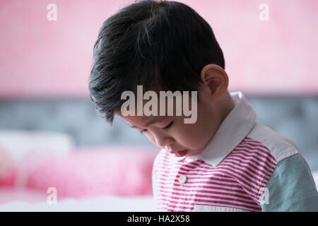 Sad boy looking at the floor Stock Photo