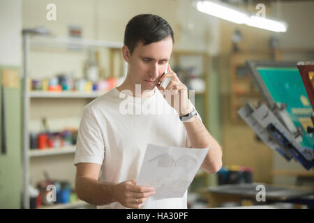 Young worker talking on the phone Stock Photo