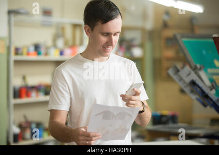 Young man holding a phone Stock Photo
