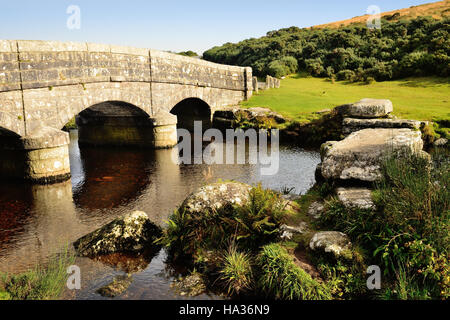 Road bridge and the remains of an old clapper bridge over the East Dart river at Bellever. Stock Photo