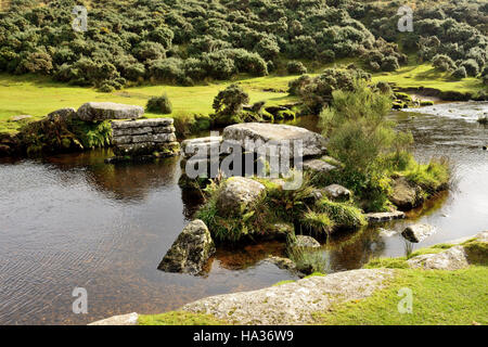 The remains of an old clapper bridge over the East Dart river at Bellever. Stock Photo