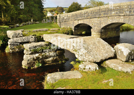 Road bridge and the remains of an old clapper bridge over the East Dart river at Bellever. Stock Photo