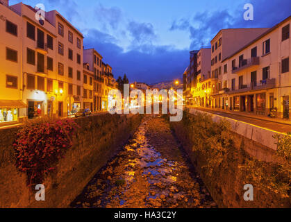 Portugal, Madeira, Funchal, Twilight view of the canal between 5 de Outubro and 31 de Janeiro streets. Stock Photo
