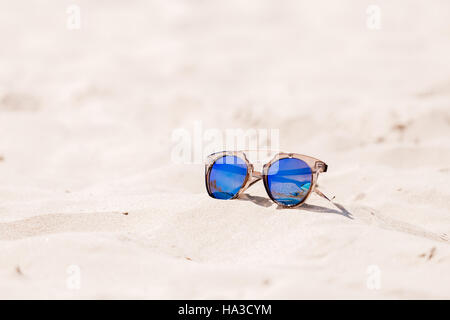 Sunglasses on sandy beach in summer Stock Photo