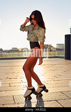 Full length of happy young woman roller skating Stock Photo