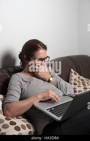Woman 50-55 years old shopping on the internet Stock Photo