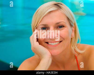 Portrait of a young woman in the indoor swimming pool Stock Photo