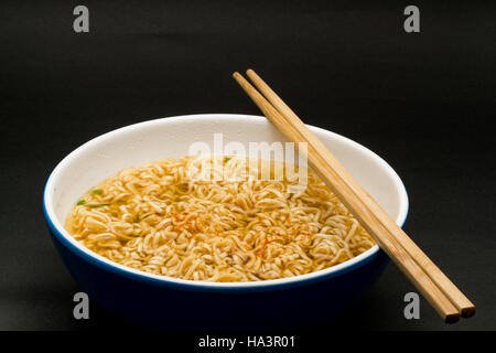 Cooked instant rice noodles in a bowl on dark background Stock Photo
