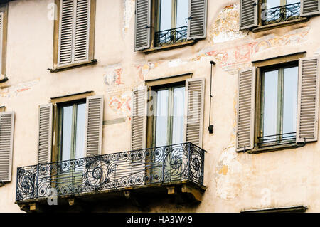 Buildings with shuttered windows and traditional Italian wrought iron balcony in Citta Alta, Bergamo, Italy Stock Photo