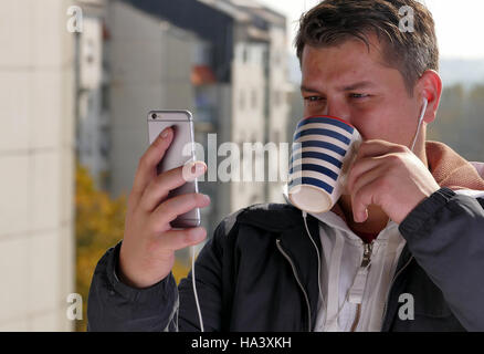 Man drinking coffee on a balcony Stock Photo