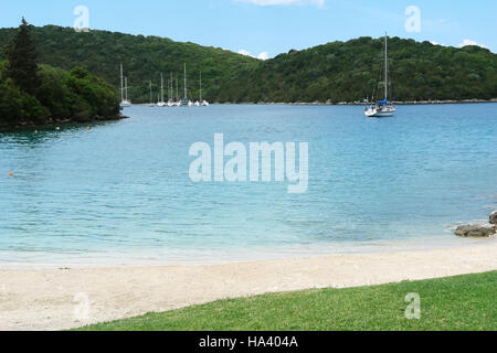 Sivota, GREECE, May 09, 2013: Landscape with green island, mountains and yacht in Ionian sea, Greece. Stock Photo