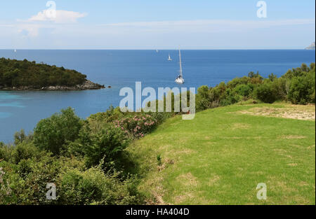 Sivota, GREECE, May 09, 2013: Landscape with green island, sea horizon and yachts in Ionian sea, Greece. Stock Photo