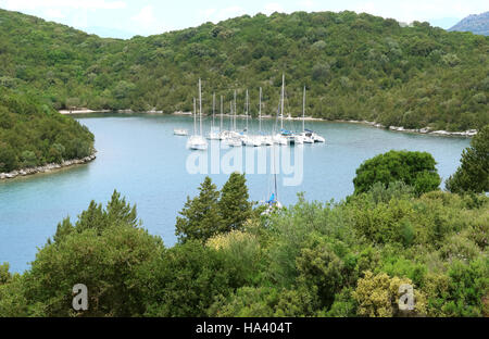 Sivota, GREECE, May 09, 2013: Landscape with green island, mountains and yachts in emerald bay in Ionian sea, Greece. Stock Photo