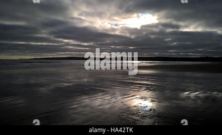 Cloud Reflections on the sand in Cayton Bay Stock Photo