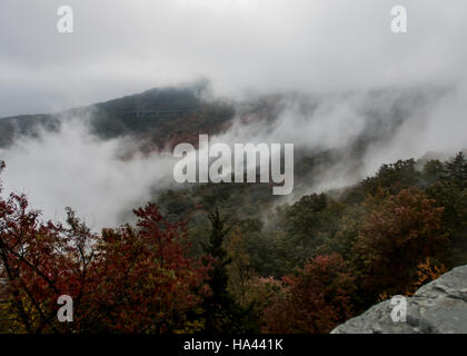 Thick Morning Fog Near Linn Cove Viaduct in early fall Stock Photo