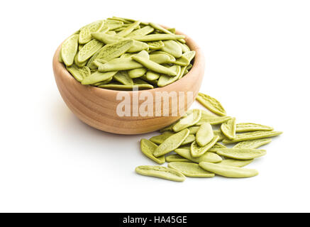 Dried italian pasta with spinach flavour in wooden bowl isolated on white background. Stock Photo