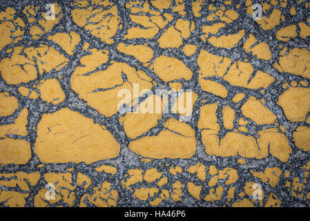 Worn Road Paint Close Up shows texture of the asphalt Stock Photo