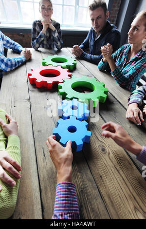 People in casual clothes with cogs of business, modern business meeting concept Stock Photo