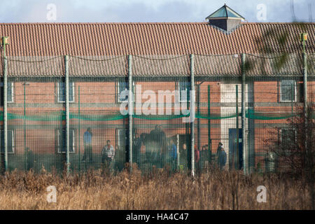 Kidlington, UK. 26th Nov, 2016. Detainees inside Campsfield House Immigration Removal Centre communicate with campaigners against immigration detention protesting outside on the 23rd anniversary of its opening to call for its closure. Credit:  Mark Kerrison/Alamy Live News Stock Photo