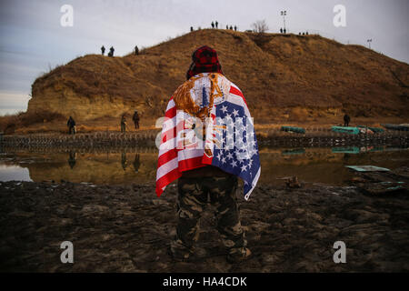 November 25, 2016 - Cannon Ball, North Dakota, U.S - JARED KOPADDY of the Comanche Nation in Oaklahoma stands as he faces authorities on the other side of the Missouri River after barbed wire was placed along the shore near the Oceti Sakowin Camp at the Standing Rock Indian Reservation in Cannon Ball, North Dakota. ''This is my very first time of being scared of being here...all I have to say is pray, just pray,'' said KOPADDY. (Credit Image: © Joel Angel Juâ€¡Rez via ZUMA Wire) Stock Photo