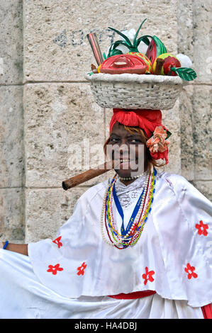 Cuban lady in traditional dress,smoking cigar,Havana, Cuba, Caribbean Stock Photo