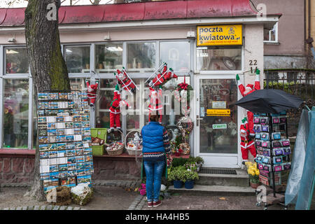 Sopot, Poland 27 November 2016 Cold day in Sopot. Lady standing outside the shop decorated on Christmas season is seen Meteorologists predict high snow fall in next few hours. Credit:  Michal Fludra/Alamy Live News Stock Photo